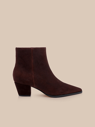 The Vesey Bootie, featuring a mahogany suede pointed toe and block heel, is displayed on a beige background.