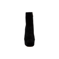 The Soho Bootie is displayed from the front against a plain white background, showcasing its black suede design, chunky platform block heel, and side zipper.