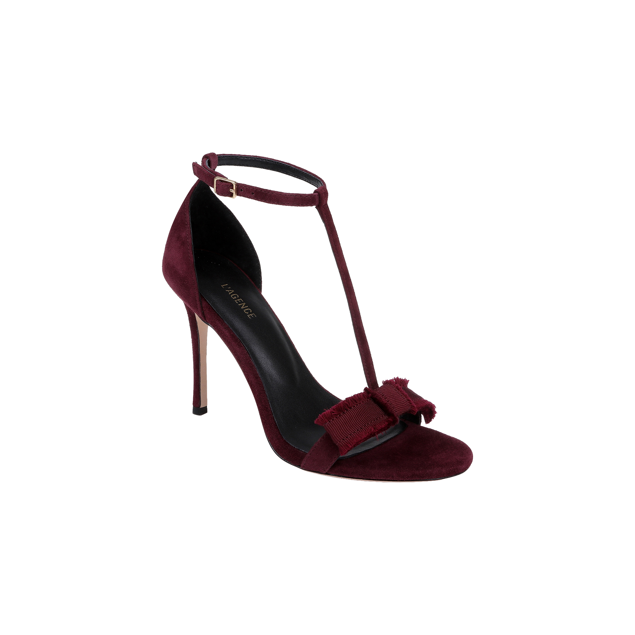 Introducing the Lerner Sandal: a high-heeled T-strap sandal featuring a burgundy suede upper, an ankle buckle, and a decorative bow at the front. Complete with a sleek black insole and a thin stiletto heel for an elegant finish.