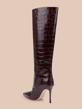 A single Lafayette Boot, made from dark brown crocodile-embossed leather and featuring a pointed toe with a high stiletto heel, is displayed against a light beige background.