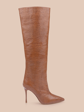 The Lafayette Boot features a tall brown silhouette with a pointed toe, high stiletto heel, and textured lizard-embossed leather, showcased on a light beige background.
