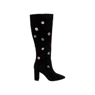 The Concourse Boot is a black suede knee-high boot featuring a high block heel and adorned with multicolored gem-like embellishments scattered across its surface, embodying the sparkling charm of crystal boots for those who desire truly statement-making embellished footwear.
