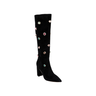 The Concourse Boot is a black suede knee-high boot featuring a chunky heel, pointed toe, and vibrant gem-like embellishments scattered across its surface—perfect for anyone who loves making a statement with embellished boots.