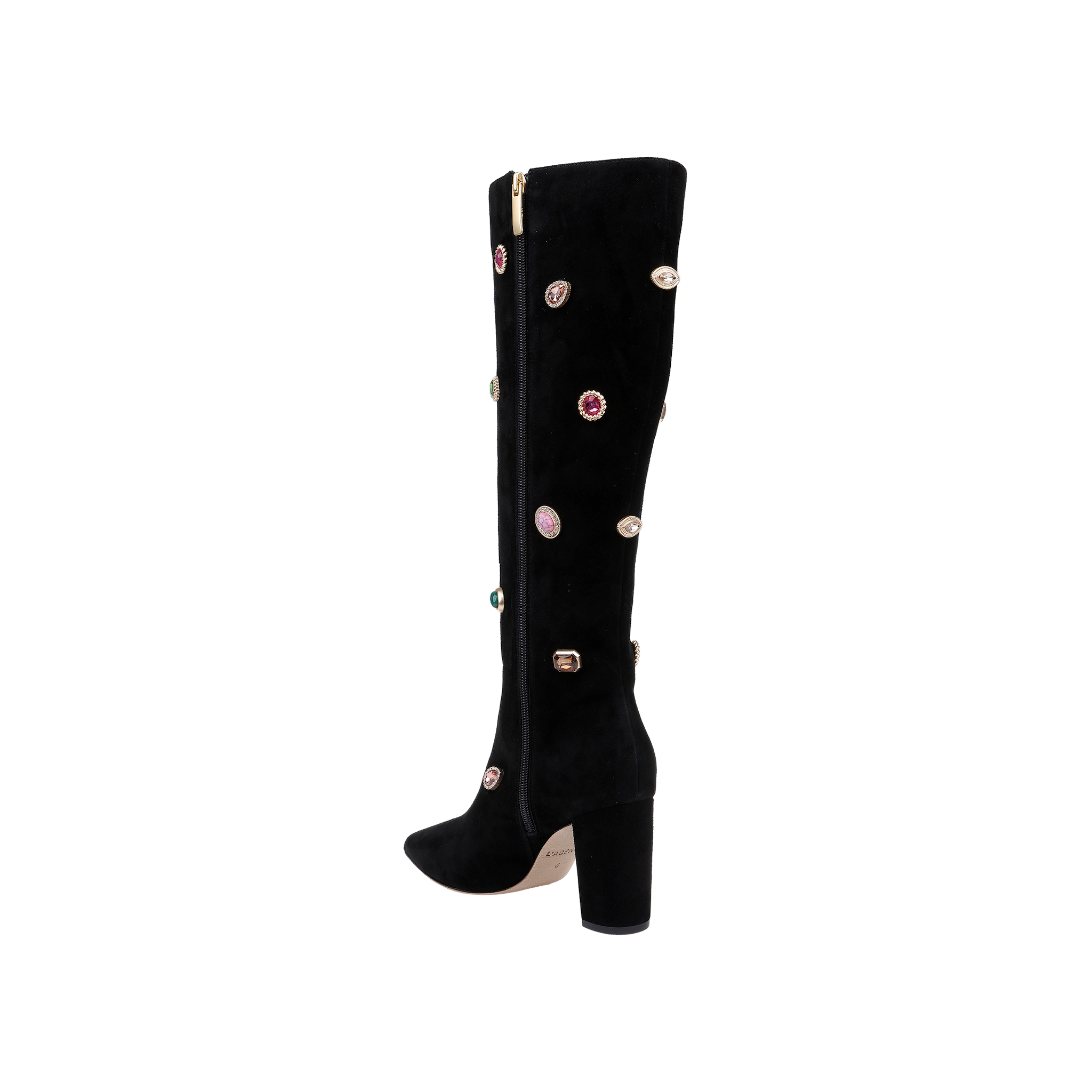 The Concourse Boot is a black knee-high boot with a chunky heel, adorned with vibrant gem-like embellishments and a gold zipper running down the side. Presented against a plain white background, these luxury statement boots are designed to elevate any outfit with their bold, sparkling accents.