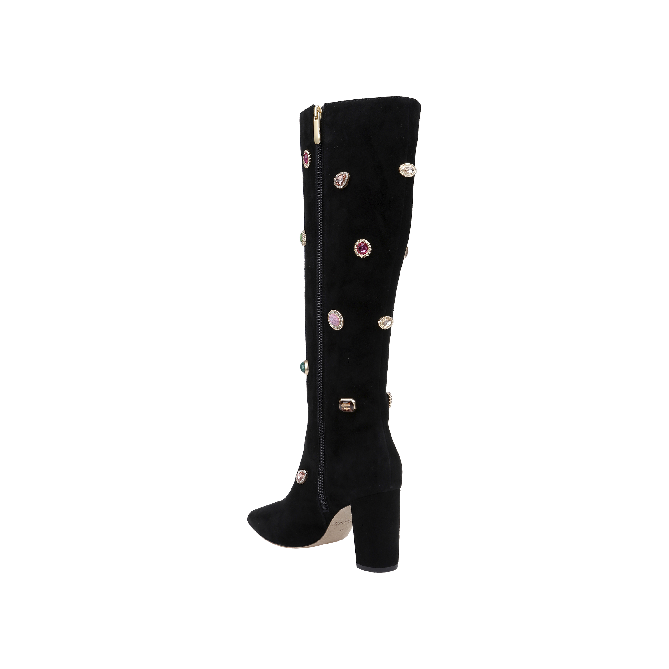The Concourse Boot is a black knee-high boot with a chunky heel, adorned with vibrant gem-like embellishments and a gold zipper running down the side. Presented against a plain white background, these luxury statement boots are designed to elevate any outfit with their bold, sparkling accents.