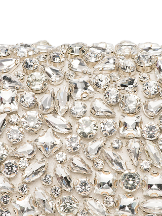 A close-up of the Verve Crystal Clutch, featuring clear, sparkling handcrafted crystals in varied shapes and sizes set on a metallic base for a dazzling statement accessory.