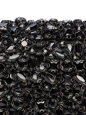 Close-up of the Victoire Crystal Clutch’s surface, densely adorned with shiny black crystals in different shapes and sizes, arranged to create a handcrafted, textured pattern ideal for glamorous evening style.