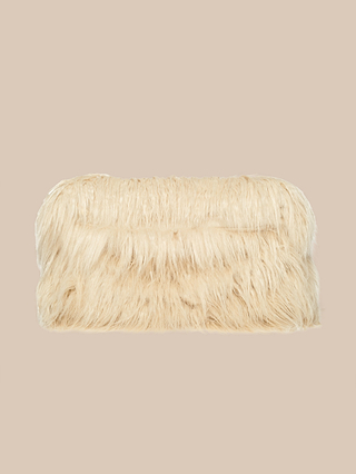 The Adelina Faux Fur Clutch, featuring long beige faux fur, offers a plush and tactile touch for an accessory that’s both chic and playful. Displayed against a plain beige background, this statement piece adds a touch of elegance to any ensemble.