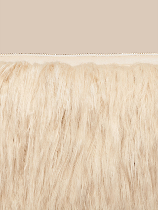 A close-up of the Adelina Faux Fur Clutch showcases its long, light beige faux fur fabric with a stitched seam running horizontally near the top against a plain beige background—perfect for adding a touch of elegance to any outfit as a subtle yet stylish statement accessory.