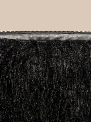 Close-up of the Adelina Faux Fur Clutch, highlighting its plush black faux fur and fluffy, textured finish against a light brown background, with a line of dark trim at the top edge—an eye-catching statement accessory.