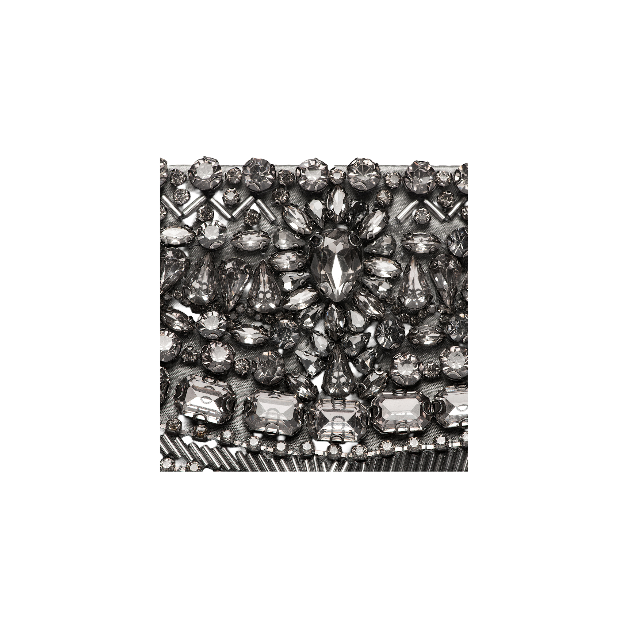 Close-up of the Eclipse Crystal Clutch, showcasing an intricate, symmetrical pattern of various shapes and sizes of silver and clear rhinestones. The sparkling crystal embellishments make this decorative surface perfect for an elegant evening accessory.