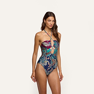 A woman wearing a Shiva One-Piece Swimsuit featuring a paisley print and a cutout detail at the bodice.