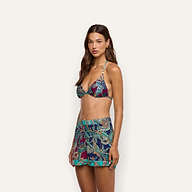 A person wears a matching bikini top and Enyo Cover-Up Short featuring a colorful paisley print and a gold chain belt.