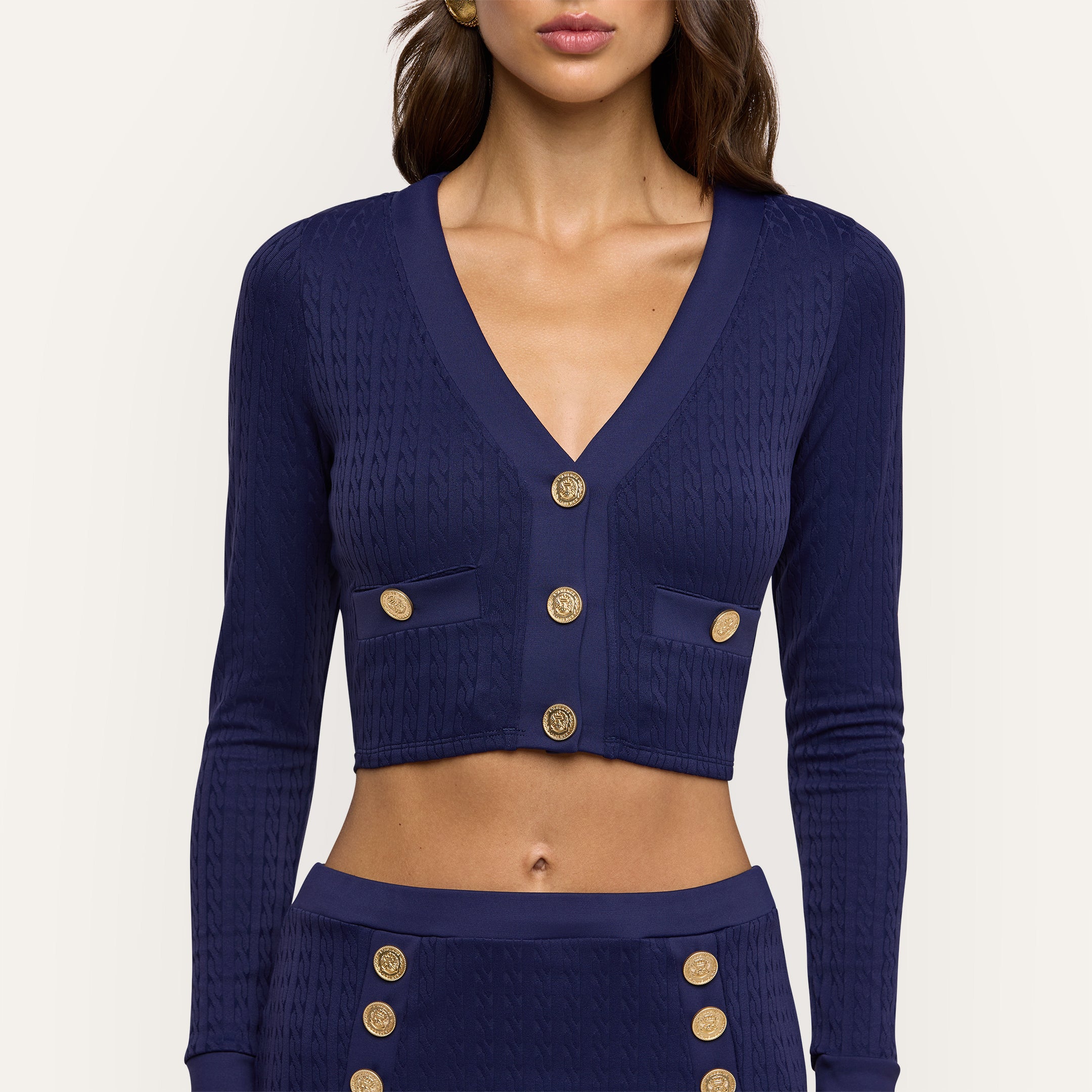 Adaline Cardigan Cover-Up in navy blue cable-knit, featuring a cropped fit, V-neck, gold buttons, and UPF 50 swim fabric.