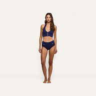 A woman wearing a dark blue, cable knit Catalina Bikini Top with button details and matching high-waisted UPF 50 bikini bottoms.