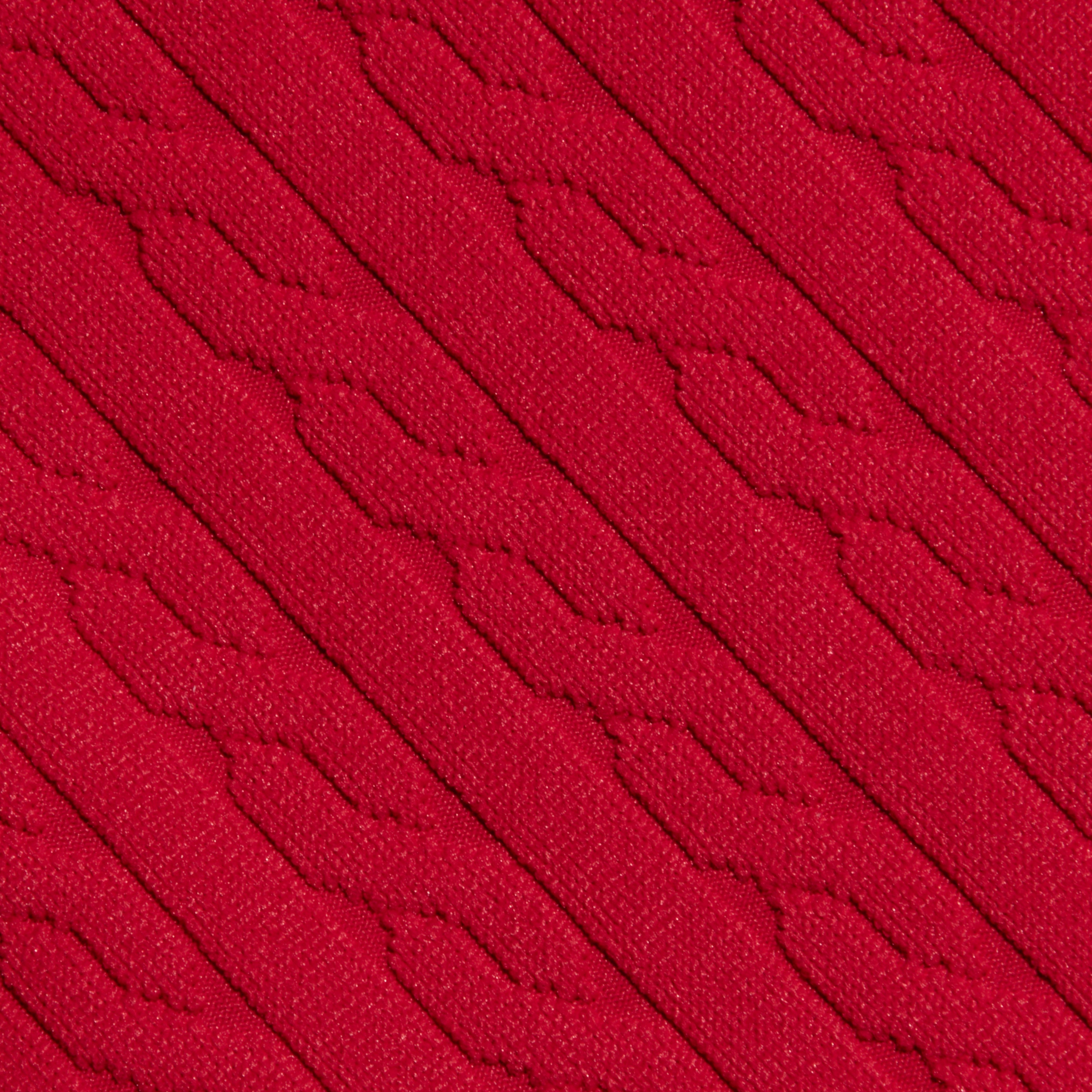 Close-up of the Playa Bikini Top in red, featuring a diagonal ribbed and textured pattern reminiscent of cable knit swimwear, creating a repeating geometric design across the surface.