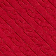 Close-up of the Jean Bikini Bottom’s red textured swim fabric, showcasing diagonal, raised patterns and a knit-like appearance. The design features repeating geometric shapes for a tactile look.