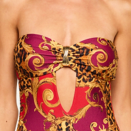 Close-up of the Emilia Bandeau One-Piece Swimsuit, showcasing a gold and red baroque and leopard print pattern with a bandeau design featuring a front cutout held by a decorative metallic clasp at the center.