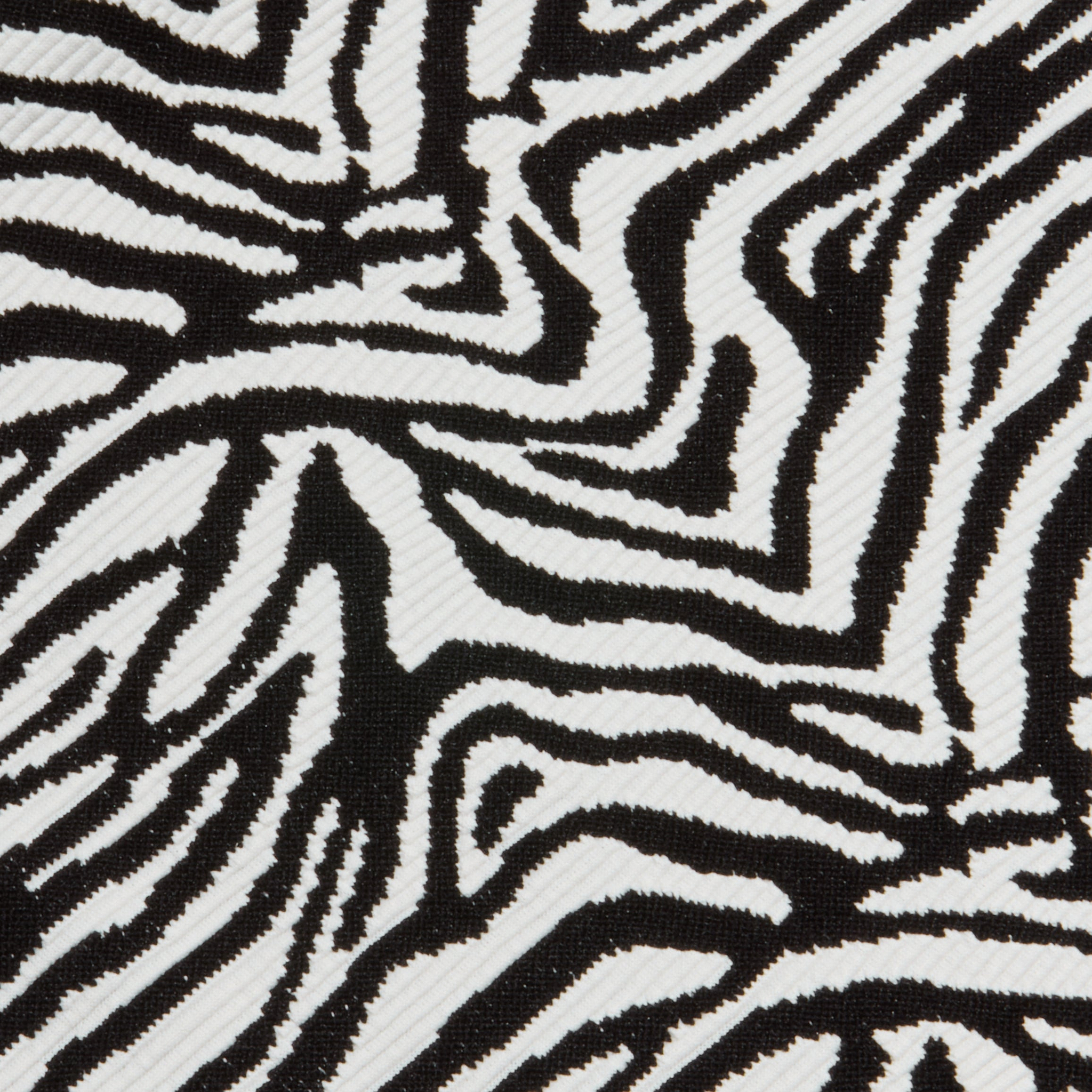 Close-up of the Karmin One-Piece Swimsuit fabric featuring bold, irregular zebra stripes and a slightly ribbed texture that enhances its striking, natural-inspired design.