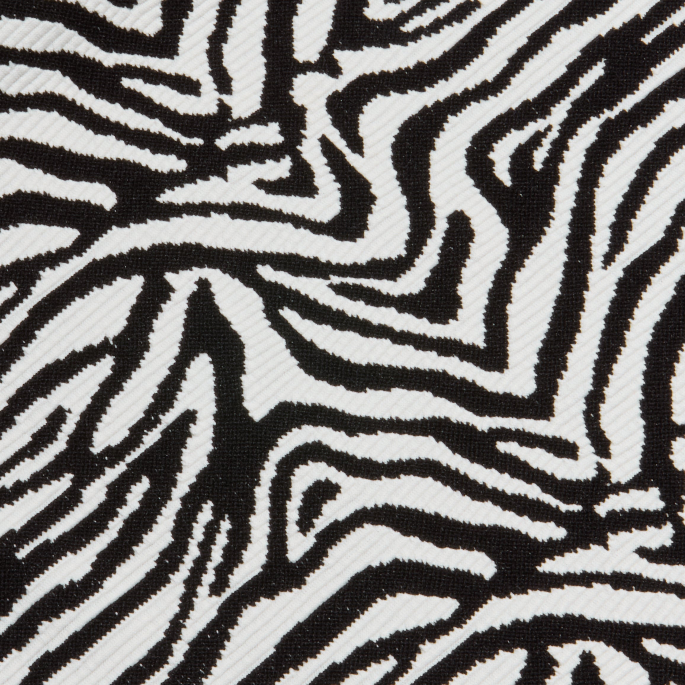 Close-up of the Karmin One-Piece Swimsuit fabric featuring bold, irregular zebra stripes and a slightly ribbed texture that enhances its striking, natural-inspired design.