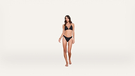 Woman in a black bikini stands barefoot against a plain white background, facing forward with a relaxed expression and posture.