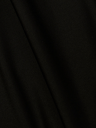 A close-up of the Emelia Bandeau One-Piece Swimsuit in black, highlighting its smooth texture, fine weave pattern, and four-way stretch nylon with a subtle diagonal fold in the fabric.