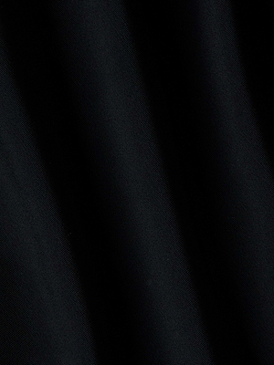 Close-up of the Sirena Halter Bikini Top in black, featuring soft, diagonal folds that resemble ruched cups and create a striking play of light and shadow across the fabric.