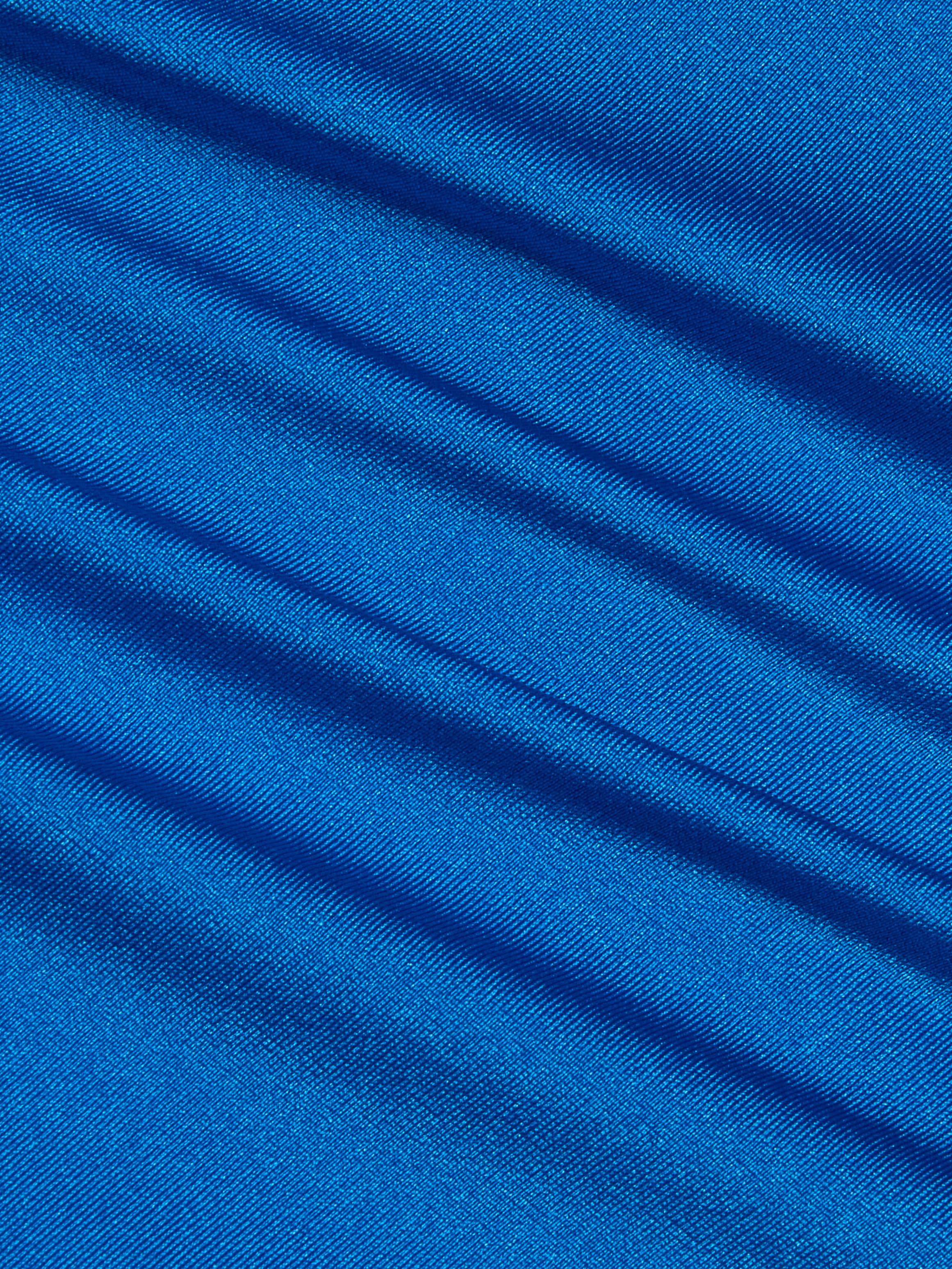 Close-up of shiny blue fabric with diagonal folds and visible texture, creating a pattern of light and shadow across the smooth surface, reminiscent of the Remi One-Piece Swimsuit.