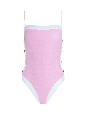The Tory Bandeau One-Piece Swimsuit is a pink, textured bouclé swimsuit with white trim, thin shoulder straps, and decorative gold buttons along the sides, shown against a white background.