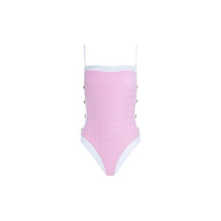 The Tory Bandeau One-Piece Swimsuit showcases a pink silhouette, accented with white trim, thin shoulder straps, and decorative gold buttons along the sides. Its textured bouclé fabric lends a sophisticated touch to this classic design.