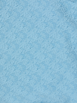Close-up of the Tory Bandeau One-Piece Swimsuit's textured light blue fabric, featuring a subtle pattern and visible fibers reminiscent of bouclé.