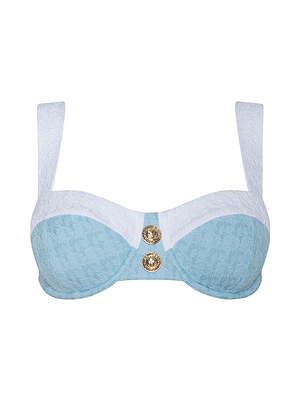 The Alexandria Bikini Top is a powder blue and white balconette style in bouclé swim fabric, featuring wide white straps and two decorative gold buttons at the center front.