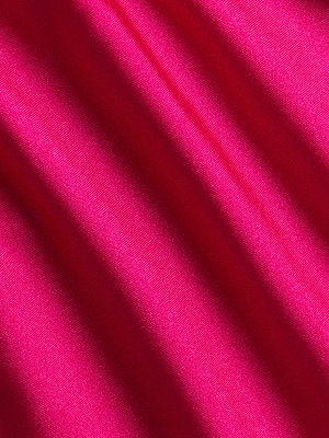 Close-up of bright pink four-way stretch nylon fabric from the Jean Bikini Bottom, featuring soft diagonal folds, smooth texture, and a slight sheen.