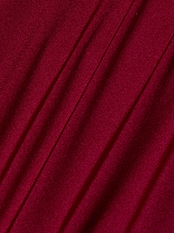 Close-up of Nicole Bikini Bottom in deep red, black cherry fabric with diagonal folds and a smooth, slightly shiny texture. The soft material and gentle shadows add depth—making it an essential swimwear piece.