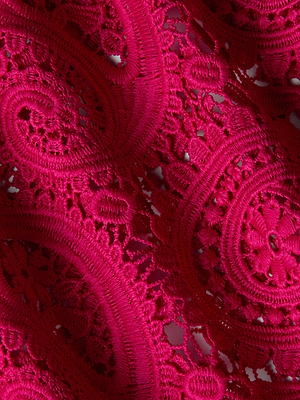 Close-up of vibrant pink sheer paisley lace fabric with intricate floral and swirling patterns—ideal for the Geraldine Cover-Up Pant, featuring delicate openwork details and wide legs.