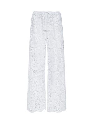 The Geraldine Cover-Up Pant features a wide-leg bohemian fit in white paisley crochet, with a scalloped hem and drawstring waist—ideal resort wear, shown against a plain white background.
