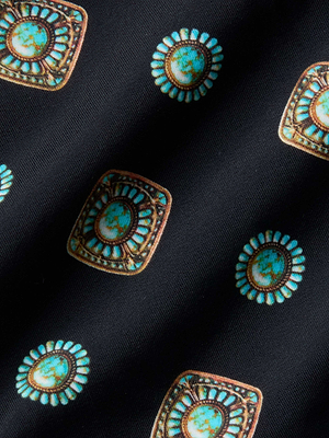 Close-up of the Jean Bikini Bottom fabric, showcasing turquoise and brown geometric motifs on black—ideal for creating a stylish high-leg swimwear look.