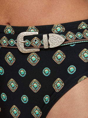 Close-up of the Vanessa High-Waisted Bikini Bottom in black, featuring a turquoise and gold geometric medallion print and an embellished waist belt with a detailed silver buckle for added style.