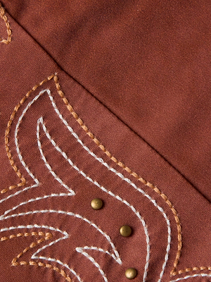 Close-up of the Lexie Bikini Top by L'AGENCE Sale, a suede-look style with curved white and tan Western embroidery and three small gold metal stud accents.