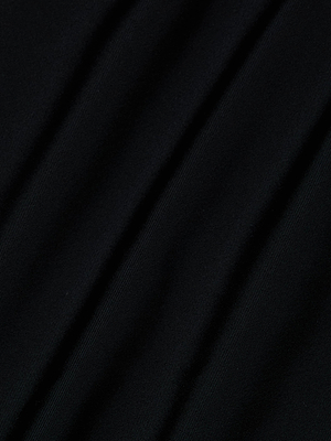 Close-up of the Shiva One-Piece Swimsuit in black, featuring four-way stretch nylon with diagonal folds and soft shadows that reveal its smooth, slightly textured surface.