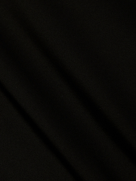 A close-up of black fabric from the Gabrielle One-Piece Swimsuit, featuring subtle diagonal folds and a fine, textured weave that evokes minimalist elegance.