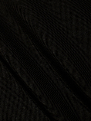 A close-up of the Gabrielle One-Piece Swimsuit in black shows fabric with a subtle texture and diagonal creases, creating gentle shadows and highlights on its sleek surface.