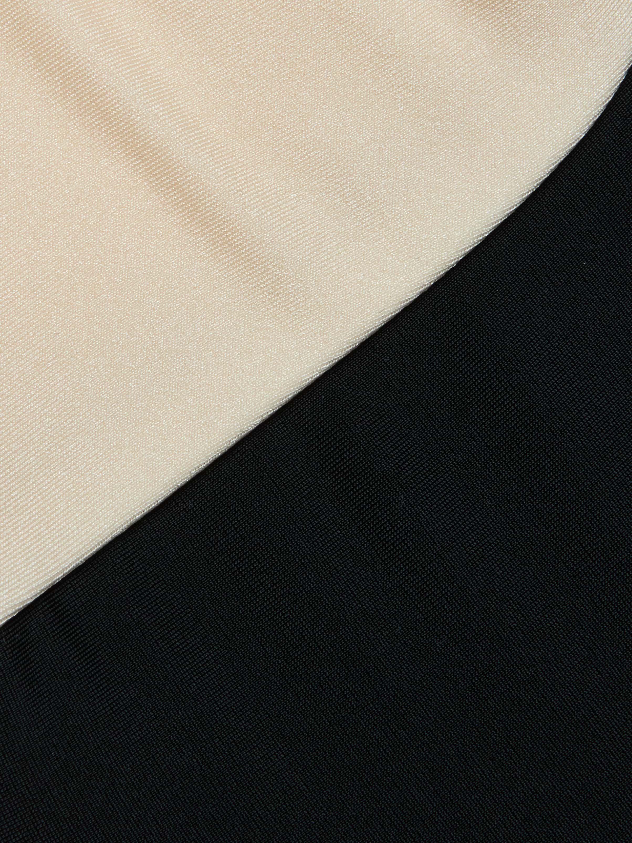 Close-up of the Emilia Bandeau One-Piece Swimsuit featuring two color-blocked fabric panels, one beige and one black, arranged diagonally with a distinct seam line separating the colors. The fabric textures are clearly visible.