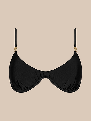 The Tenali Bikini Top, a black bra-style bikini with adjustable straps and gold accents, is shown against a beige background, combining elegant style and supportive comfort.