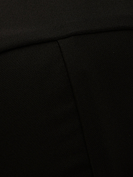 Close-up of the Alexandria Bikini Top in black, showcasing its textured fabric with a visible diagonal seam and a fold near the top of the image.