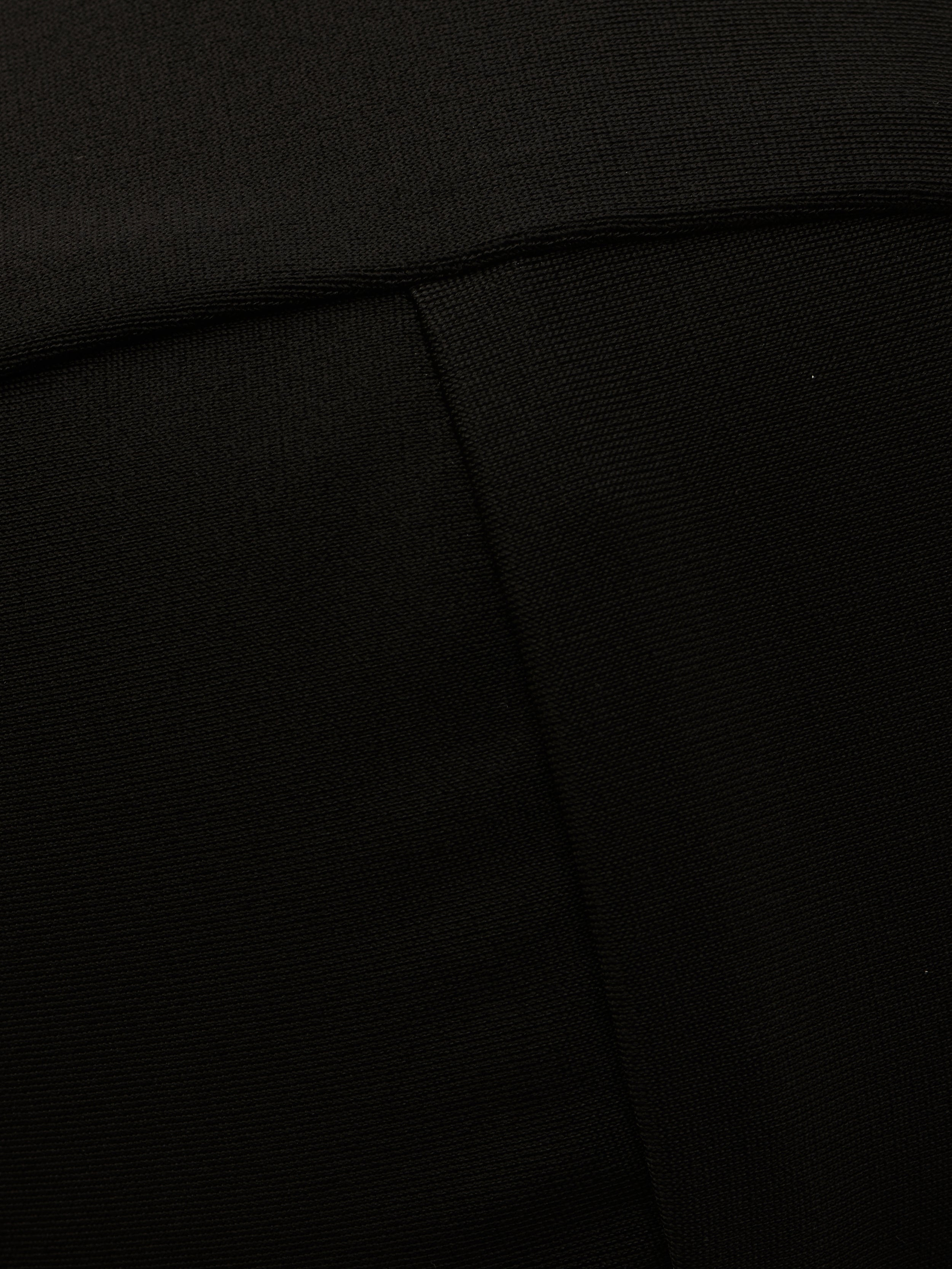 Close-up of the Alexandria Bikini Top in black, showcasing its textured fabric with a visible diagonal seam and a fold near the top of the image.