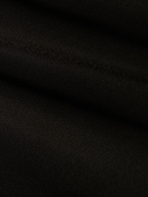 Close-up of the Ashleigh Bikini Bottom in black, featuring a soft texture, subtle diagonal folds, fine lines, and a smooth matte finish.