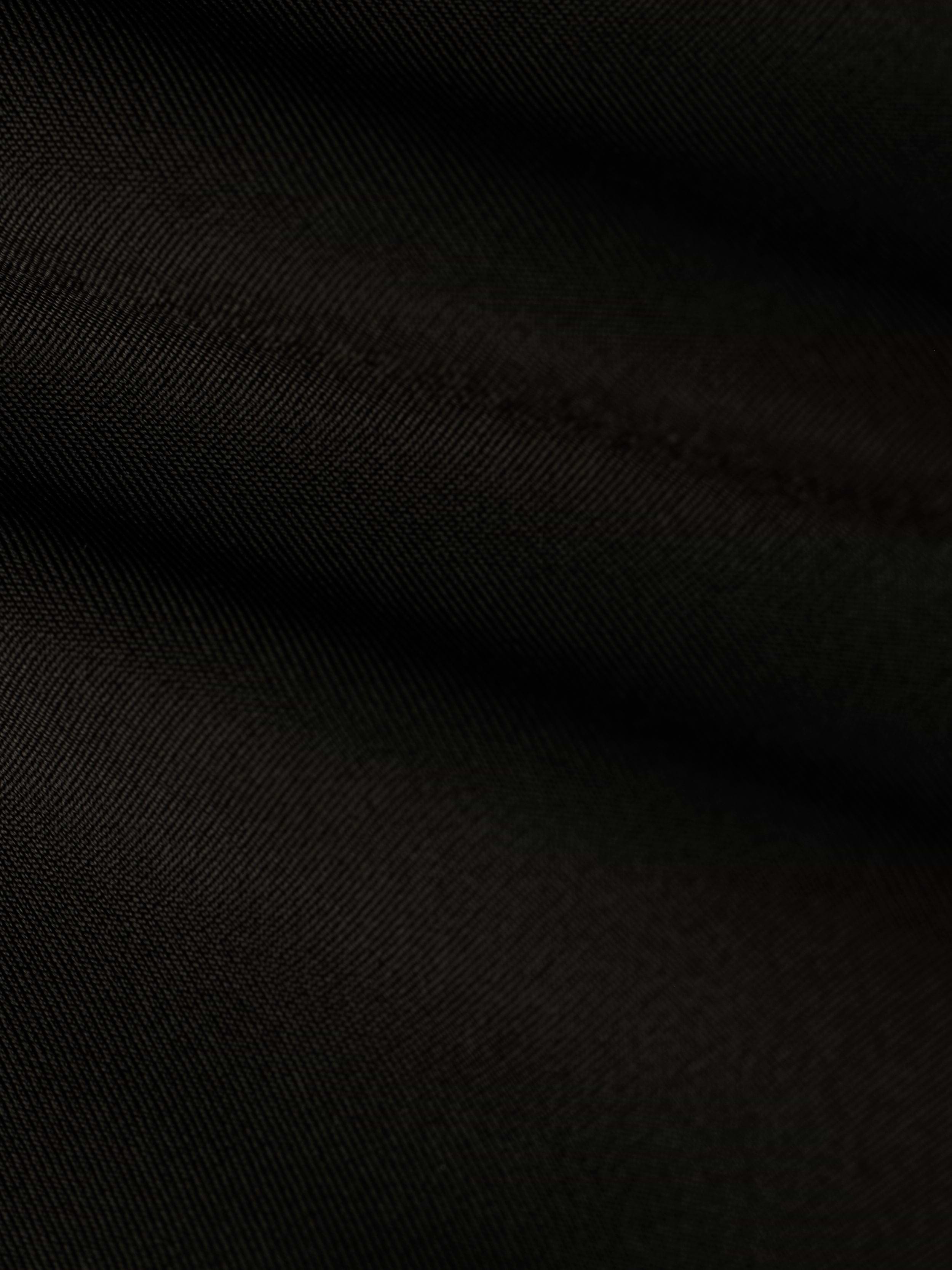 Close-up of black fabric with diagonal weave pattern and soft folds, highlighting the fine texture and subtle highlights on the surface, reminiscent of the refined Ashleigh Bikini Bottom.