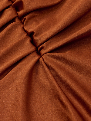 Close-up of the Aubrey Ruched One-Piece Swimsuit in shiny, rust-colored satin, featuring gathered center ruching that creates soft folds and a richly textured look.