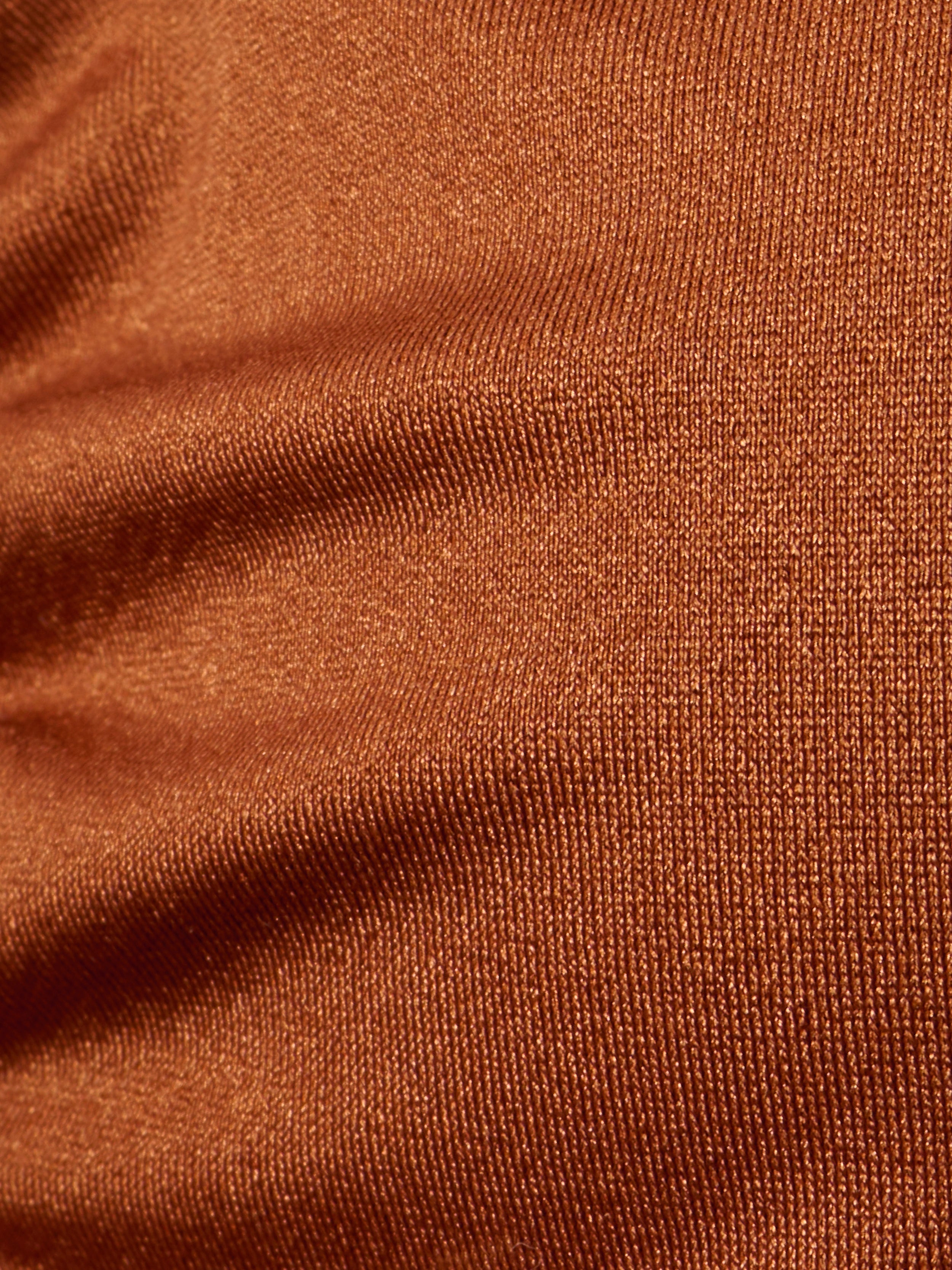 Close-up of brown, textured fabric with visible weave pattern and slight wrinkles on the Annabelle Triangle Bikini Top, creating a sense of depth and softness—perfect for an adjustable fit or luxe hardware details.
